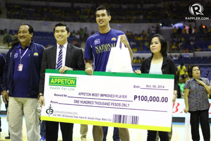 Troy Rosario holds a check and goody bag after winning the Most Improved Player award. Photo by Josh Albelda