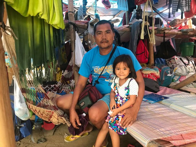 FAMILY. Bernie de los Santos, packing plant worker and NAMASUFA union member and his 3-year-old daughter, Bea, will be spending Christmas at the protest camp. 