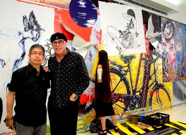COLLABORATION FOR THE GLOBE GENERATION 3 STORES. Globe's Joe Caliro (right) with renowed local artist Ross Capili lead the live art painting on the wall cover of the upcoming Globe Generation 3 store in North EDSA, Quezon City. Photo from Globe Telecom  