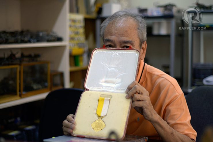 RECOGNITION. Yamsuan shows the Pro Ecclesia et Pontifice medal—a cross of honor given by the Vatican for his service. Photo by LeAnne Jazul/Rappler