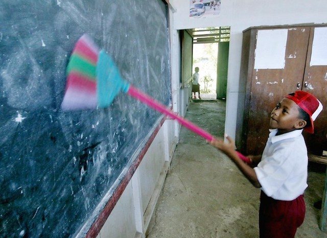 The same goes for school buildings. In this image, a student cleans the blackboard inside his classroom after school reopened in Banda Aceh on January 13, 2005, just two weeks after the tsunami struck.

