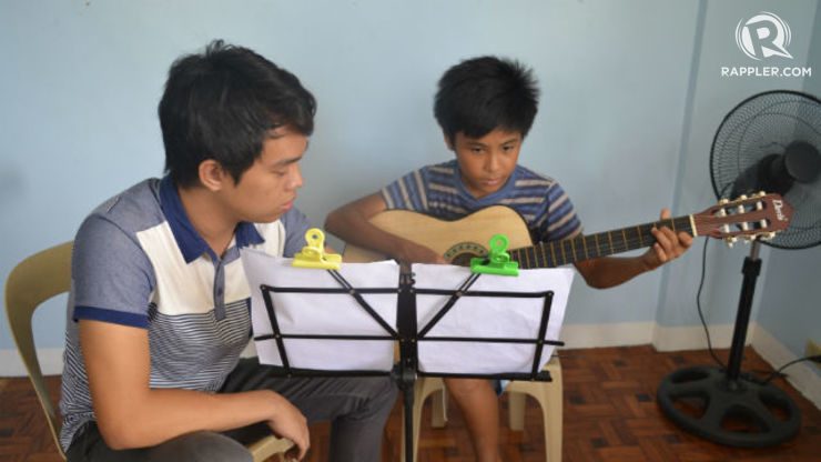 MUSIC LESSONS. Volunteers teach children beneficiaries how to play various instruments in the center.