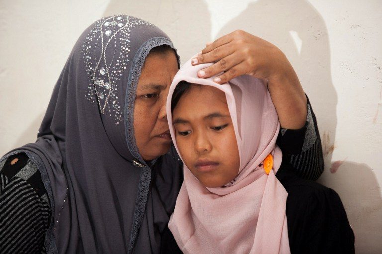 REUNITED. Jamaliah (L) hugs her daughter Raudhatul Jannah (R) after they were reunited in Meulaboh, Aceh, in August 2014, almost 10 years after the young girl was swept away by the devastating 2004 tsunami. Photo by AFP 