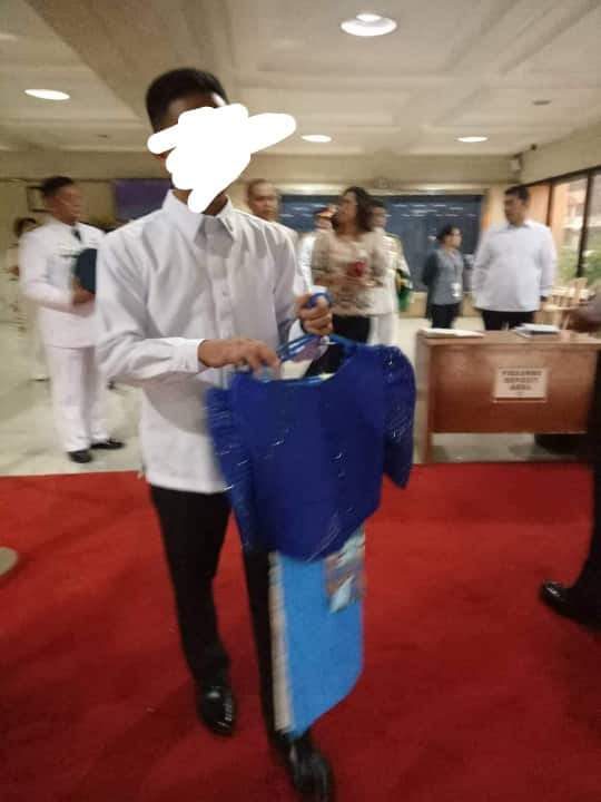 FIRST ATTEMPT. A SONA security staff member tries to get the top and sash that Elago is going to wear for the SONA. But her staff gets these back. Photo from Kabataan  