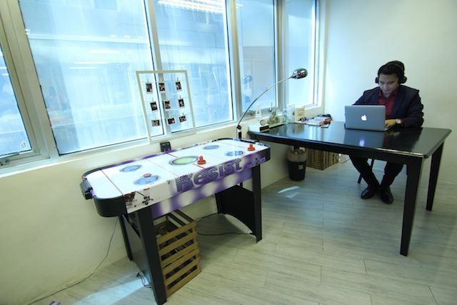 MILLENNIAL WORKPLACE. Montgomery Fitch founder Luis Arcangel works next to the company's air hockey table 