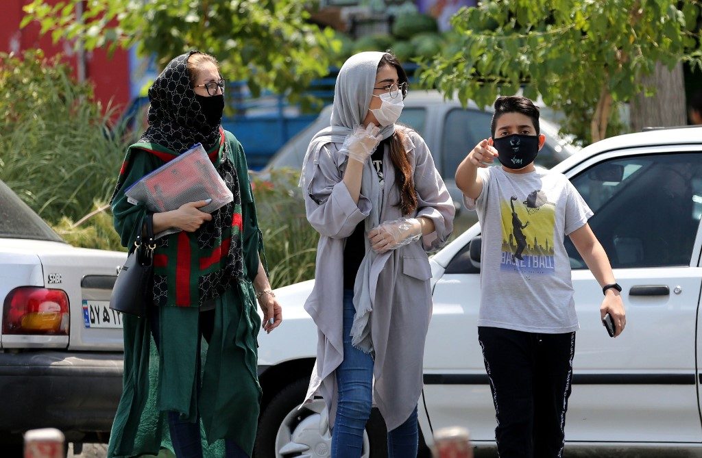 CASES RISING. Pedestrians wearing protective masks due to the coronavirus walk along a street in the Iranian capital Tehran on June 28, 2020. File photo by Atta Kenare/AFP
  