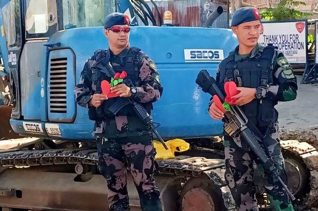 READY FOR INSPECTION. Policemen carry paper hearts and roses for their Valentine's Day inspection. PNP-ARMM Photo   