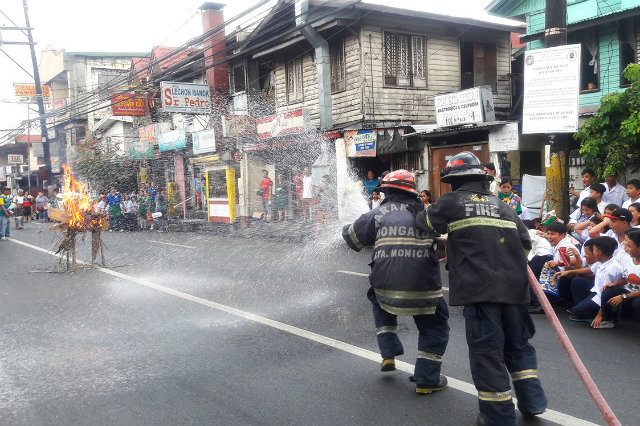 DRILL. Volunteer firefighters in Barangay Don Galo put out a fire during the nationwide earthquake drill. Photo by Rendell Sanchez / Rappler  