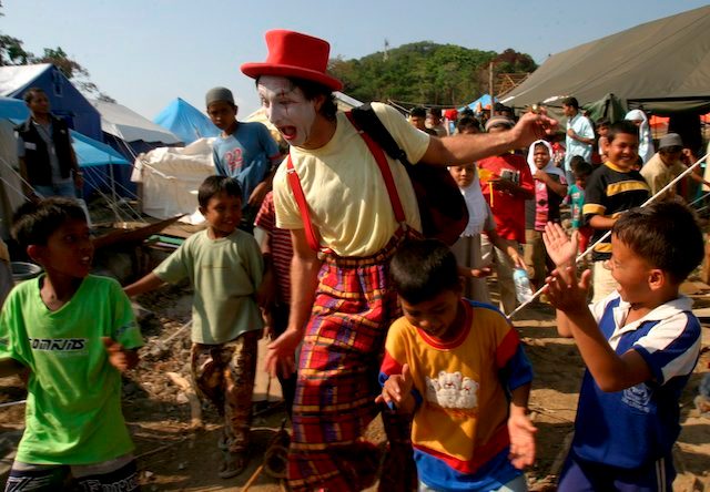But not all injuries were physical. Here, Elvo the Clown, alias Aaron Ward from New Zealand, performs in front of Acehnese children, many of who suffered from trauma.
