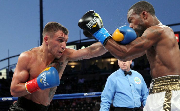 SECOND TIME THE CHARM. Vasyl Lomachenko (L) lands a straight left hand on Gary Russell. Photo by Chris Farina - Top Rank