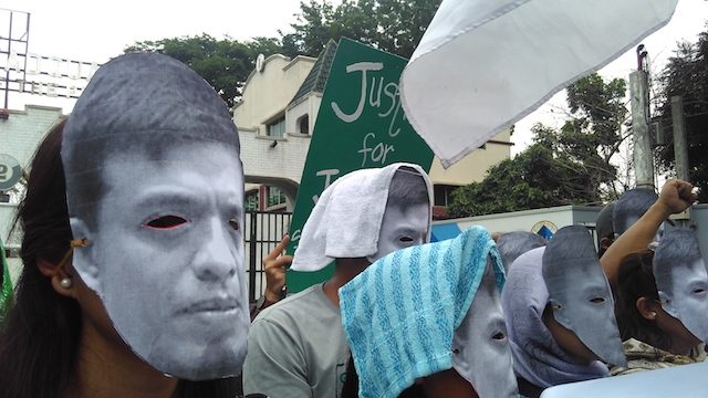 MASKED PROTESTERS. Protesters wearing Jonas Burgos masks gather at the gate of Camp Aguinaldo to commemorate the anniversary of his disappearance. Photo by Desaparecidos 