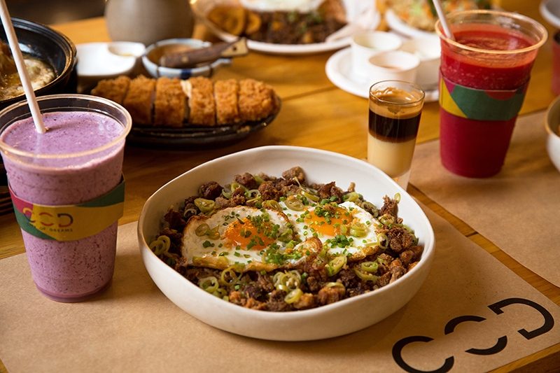 GASTRONOMICAL DELIGHTS GALORE. Have a sip of a refreshing Berries Smoothie from Juiced while gorging on the best-selling Sisig Rice of Little Flour. Photo courtesy of City of Dreams Manila 
