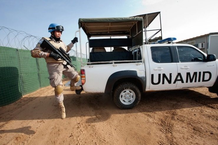 In this file photo, a member of a Formed Police Unit serving with UNAMID, arrives at the Community Policing Centre of the Abu Shouk IDP Camp during his morning patrol, 05 August 2012, El Fasher, Sudan. Albert González Farran/UN Photo