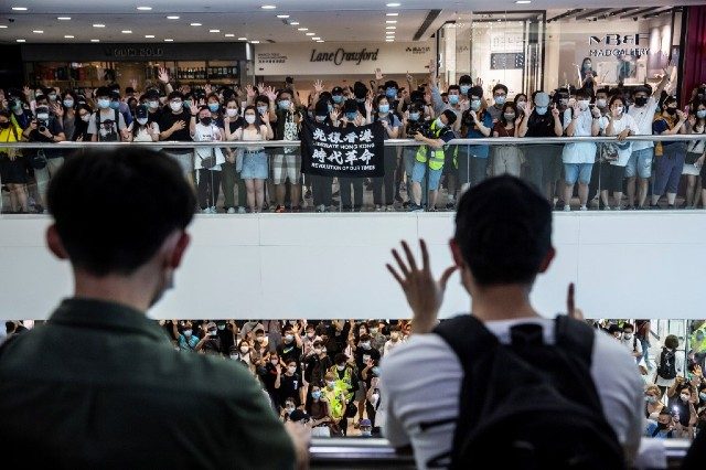 Riot police chase Hong Kong Mother’s Day protesters
