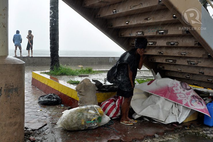 UNSHELTERED. Sidewalk vendors and the homeless huddle under a footbridge at the boardwalk of Roxas Boulevard in Manila. Photo by Rappler