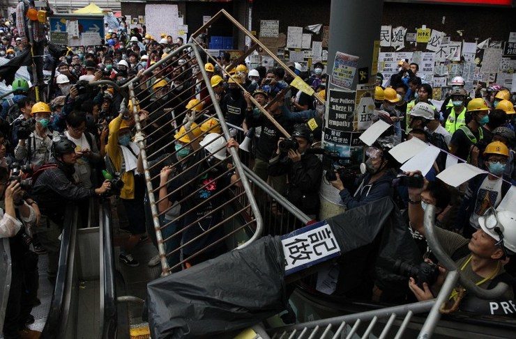 Hong Kong students face pepper spray, police batons