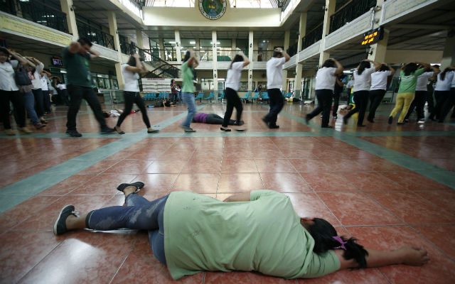 Marikina city hall employees evacuate to safety during the nationwide earthquake drill. Photo by Ben Nabong/ Rappler 