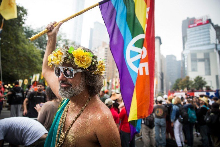 RAINBOW WARRIOR. People organize to march in the People's Climate March, which calls for drastic political and economic changes to slow global warming. File photo by Andrew Burton/Getty Images/AFP