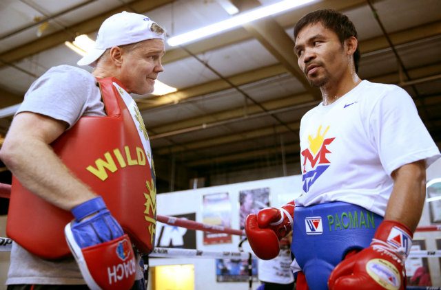 Freddie Roach and Manny Pacquiao share a glance during training. Photo by Chris Farina - Top Rank 