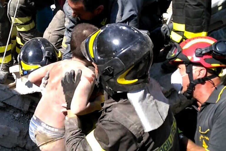 RESCUED. This photo released by Italy's Vigili del Fuoco (firemen) shows Mattias, an Italian boy who was trapped in the rubble of his collapsed house, being rescued by Italian firemen, in Ischia, on August 22, 2017. Handout photo from Vigili del Fuoco/AFP  