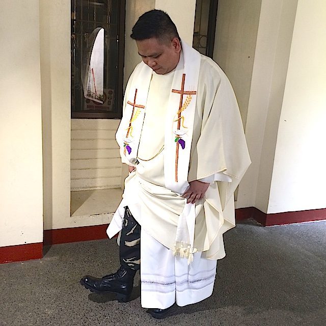 CASSOCKS AND COMBAT BOOTS: Father P2Lt Tyrone Narisma shows his combat boots