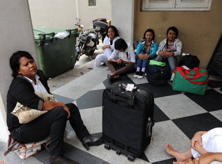 DOMESTIC WORKERS. Indonesians wait for their transportation to a maid agency after going through medical check in Singapore on in March 2012. Singapore's decision to grant a mandatory weekly day off for foreign maids was welcomed by social workers and human rights groups, but some employers were unhappy. File photo by Roslan Rahman/AFP 
