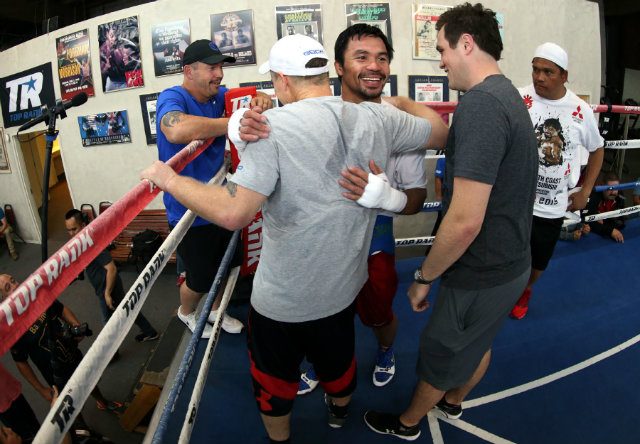 Manny Pacquiao hugs trainer Freddie Roach after a workout. Photo by Chris Farina - Top Rank 