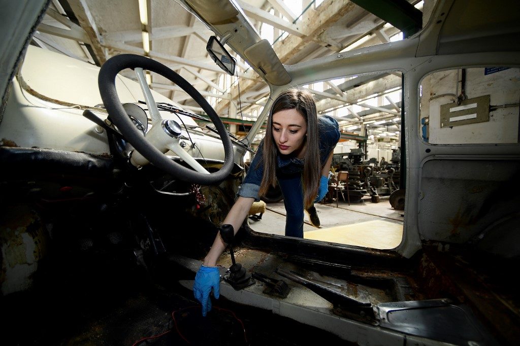 PASSION. Giovanna Parascandolo, 23 years old, developed her passion for vintage cars through the internet and YouTube were she learned from restoration communities, and later posted her own restoration work.
Photo by Filippo Monteforte/AFP
  