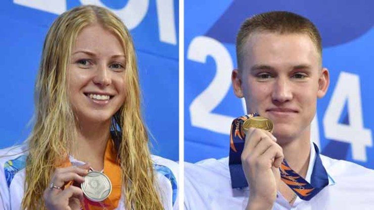 VERY NICE. Silver medalists Yekaterina Rudenko (L) of Kazahkstan poses with her medal on the podium after the women's 50m backstroke swimming event, while Kazakhstan's gold medalist Dmitriy Balandin poses with his medal after the men's 100m breaststroke. File photo by Philippe Lopez/AFP