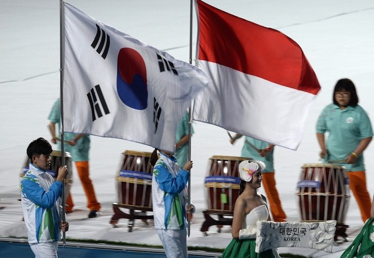 		The South Korean flag is carried with the Indonesian flag during the closing ceremony of the 2014 Asian Games at The Incheon Asiad Main Stadium in Incheon on Oct. 4, 2014. Photo by Manan Vatsyayana/AFP