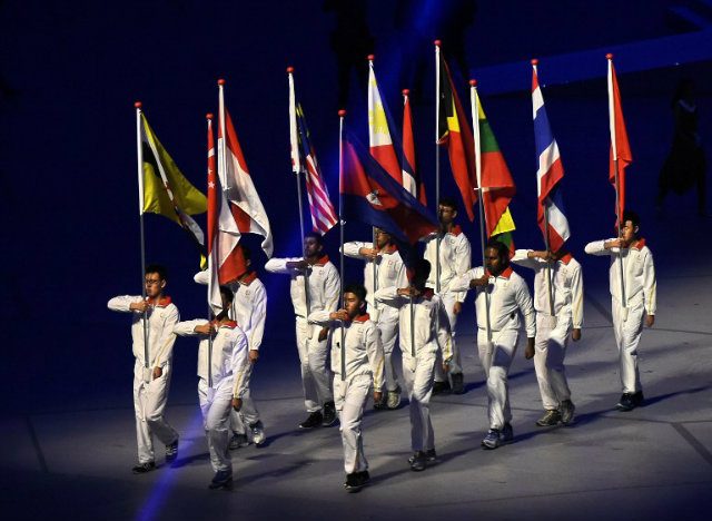 The SEA Games flag-bearers march during the opening ceremony. Photo by Roslan Rahman/AFP 