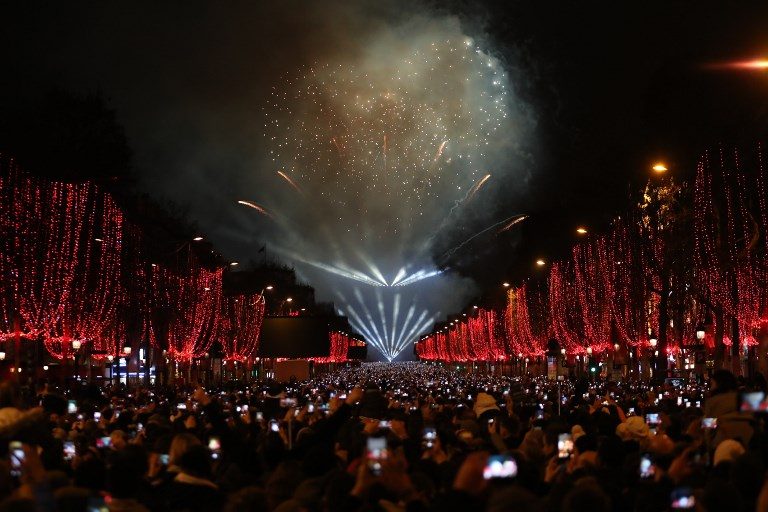 FRANCE. Fireworks explode over the Arc de Triomphe on the Champs-Elysees for New Year's celebrations in the French capital Paris on January 1, 2019. Photo by Zakaria Abdelkafi/AFP 