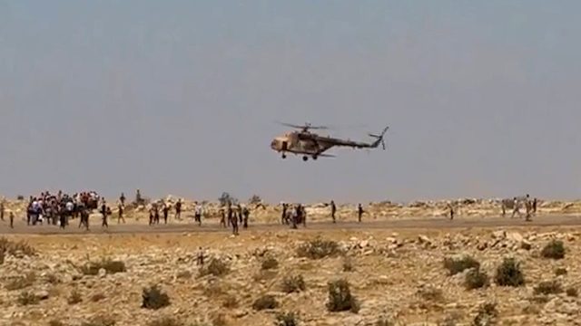 FLEEING. A screenshot provided on 13 August 2014 taken from a video by Austrian Politician Michel Reimon shows Iraqi Yazidi refugees gathering near a helicopter in northern Iraq, 10 August 2014. Michel Reimon/Handout/EPA