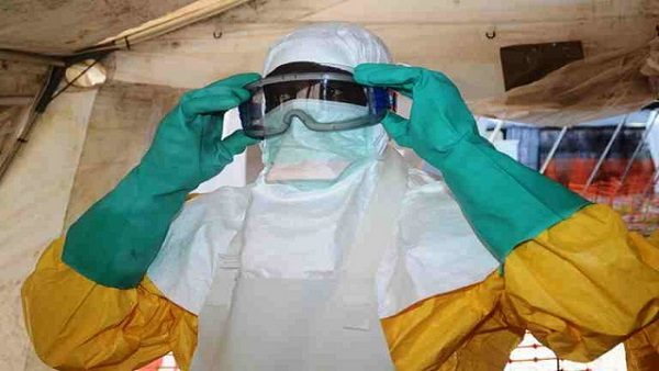 EBOLA TREATMENT. A picture taken on June 28 shows a member of Doctors Without Borders (MSF) putting on protective gear at the isolation ward of the Donka Hospital in Conakry, where people infected with the Ebola virus are being treated. Photo by AFP/Cellou Binani