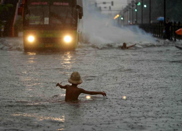 LIKE ONDOY? A Filipino child frolics on flood waters brought by typhoon Fung-Wong at a street in Manila, the Philippines, September 19, 2014. Photo by Ritchie B. Tongo/EPA