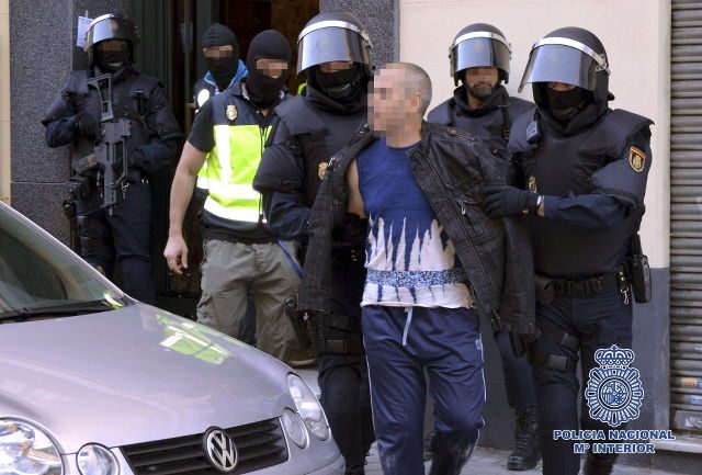 ARREST. A handout TV grab made available by Spanish Policia Nacional (National Police) arresting a suspected member of a jihadist cell in Madrid, central Spain, June 16, 2014. Spanish Policia Nacional/EPA