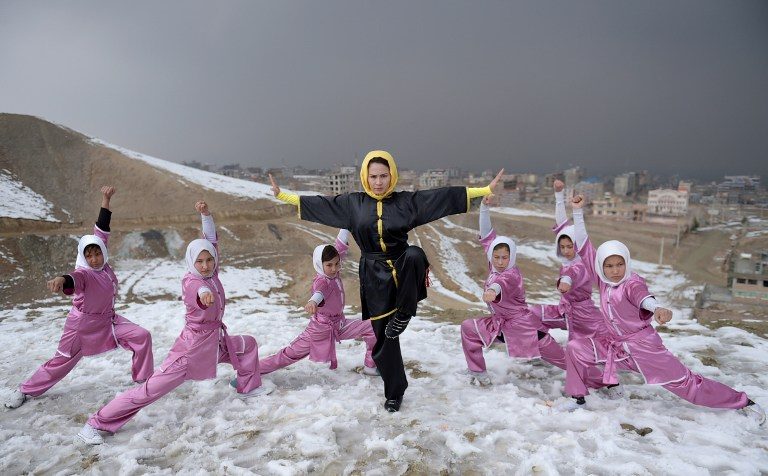 MARTIAL THERAPY. Sima Azimi (C), Afghanistan's first female wushu trainer, leads a group of 20 Afghan women, aged between 14 and 20. Photo by Wakil Kohsar/AFP   