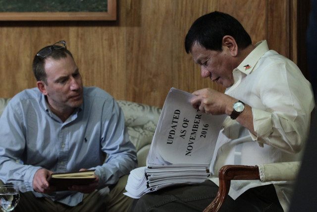 SHOW AND TELL. President Rodrigo Duterte shows Ioan Grillo his thick list of suspected drug personalities, a document no Filipino journalist has seen up close. Photo by King Rodriguez/Presidential Photo  