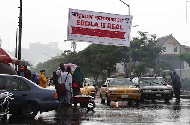 IN YOUR FACE. Photo made available 27 July 2014 of an Ebola poster being placed above a street in downtown Monrovia as Liberia marked its 167th Independence anniversary on 26 July 2014. Ahmed Jallanzo/EPA
