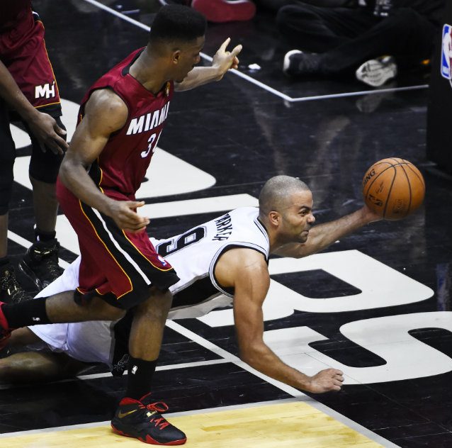 Tony Parker of the San Antonio Spurs tries to save possession as Norris Cole of the Miami Heat looks on. Photo by Ashley Landis/EPA