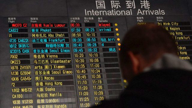 MISSING PLANE. The arrival board at the Beijing Airport showed the flight MH370 in red text. It was the Malaysia Airlines Boeing 777-200 plane, which lost contact with air traffic authorities on March 8, 2014. Photo by Mark Ralston/AFP