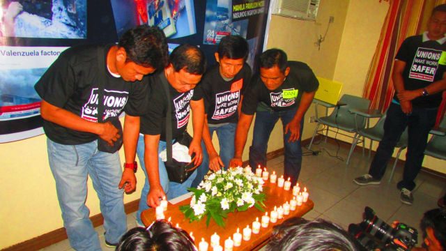 Labor groups light candles to call for better working conditions ahead of May 1