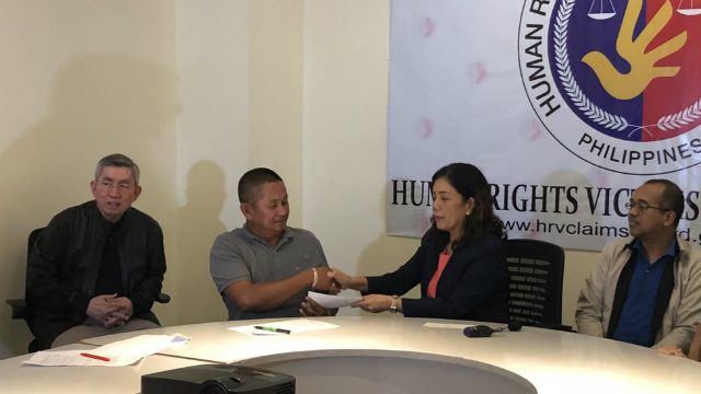 VICTIMS. HRVCB Chairperson Lina Sarmiento with board mebers Atty Wilfred Asis and Atty Galuasch Ballaho distribute checks to eligible claimants. Photo from Atty Ross Tugade of HRVCB 