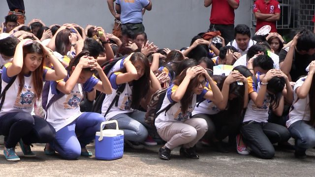 QUAKE READY? Students from the Philippine School for Business Administration conduct an earthquake drill before the start of the memorandum signing. 