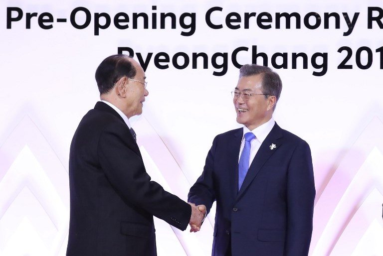 TWO KOREAS. South Korea's President Moon Jae-in (R) shakes hands with North Korea's ceremonial head of state Kim Yong Nam (L) during a ceremony reception ahead of the Pyeongchang 2018 Winter Olympics opening ceremony in Pyeongchang on February 9, 2018. Photo by Yonhap/AFP   