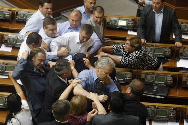 SCUFFLE. Deputies of the All-Ukrainian Union 'Svoboda' party attack the head of the Communist parliamentary faction Petro Symonenko (C) as they attempt to remove him from the hall during a Ukrainian parliament sitting in Kiev on July 23, 2014. Photo by Anatolii Stepanov/AFP  