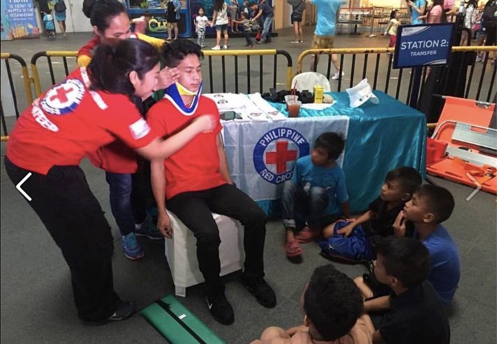 WORLD FIRST AID DAY. A Philippine Red Cross (PRC) volunteer demonstrates to children common first aid skills on September 10 at the Manila Ocean Park, where the humanitarian organization is observing the World First Aid Day. Photo by PRC 