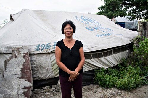 DIFFICULT. Salome Lacaba still lives with her sons in a tent located at Brgy. 88, a year after Yolanda. Photo by Arvin Cadigoy