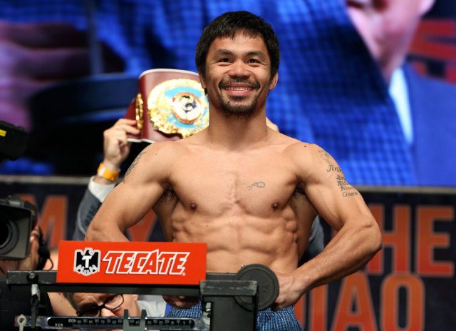 Manny Pacquiao smiles as he weighs in. Photo by Chris Farina - Top Rank 