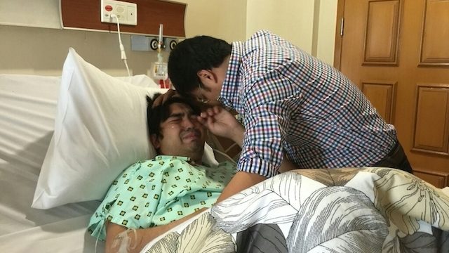 HOSPITAL VISIT. Detained senator Ramon 'Bong' Revilla Jr makes an emotional visit to son Jolo, who is confined at the hospital for a gunshot wound. Photo courtesy of the office of Senator Revilla 